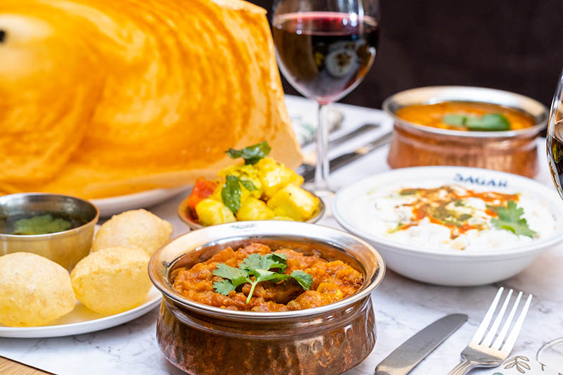 a table with South Indian vegetarian dishes